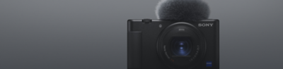 Front view of black Sony compact camera with microphone attached